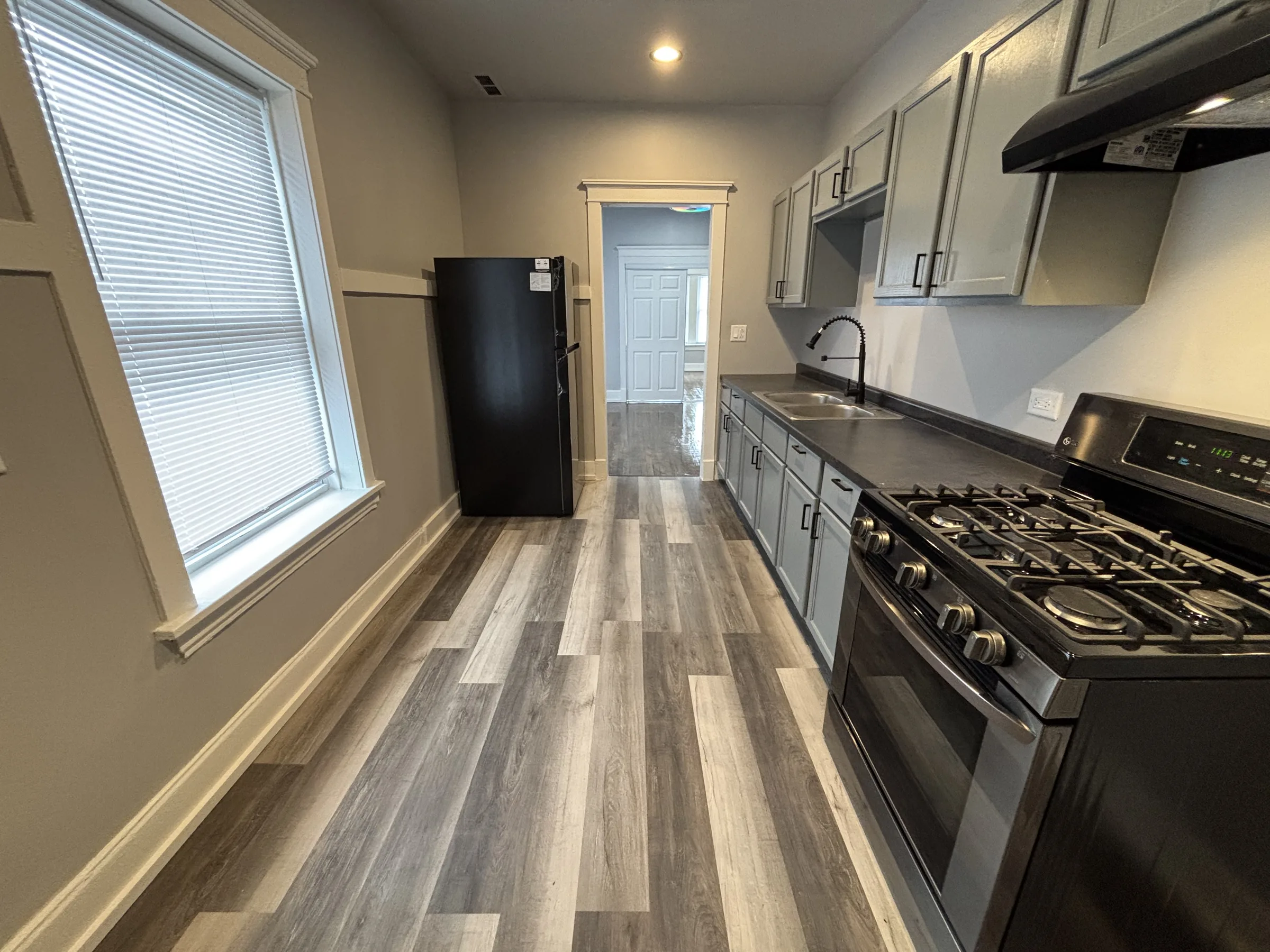 Finished kitchen with painted cabinets and new flooring