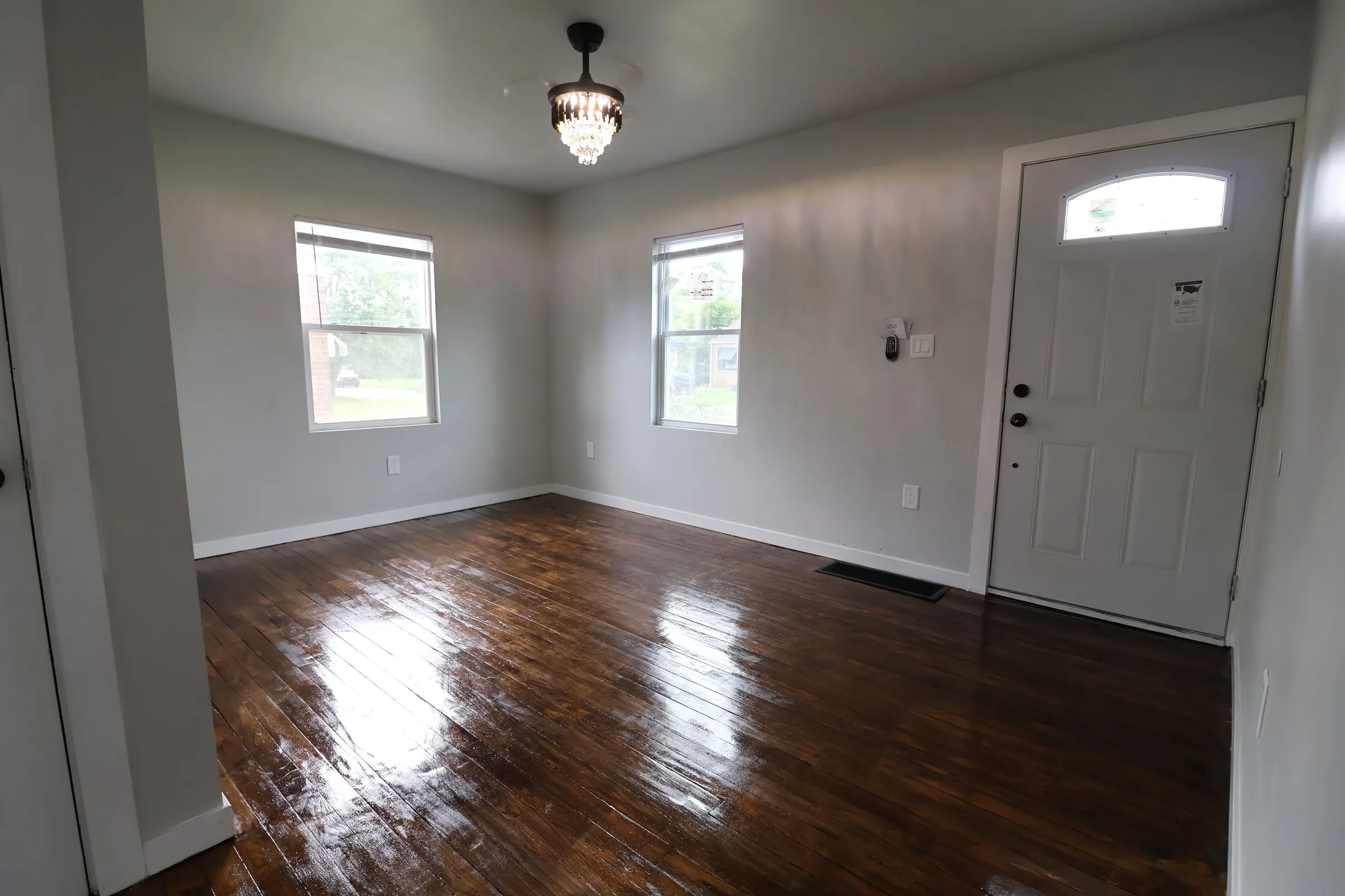 Finished living room with hardwood floors and windows